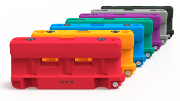 Yodock barriers in red, orange, yellow, blue, green, purple, grey and black, fanned out in a row
