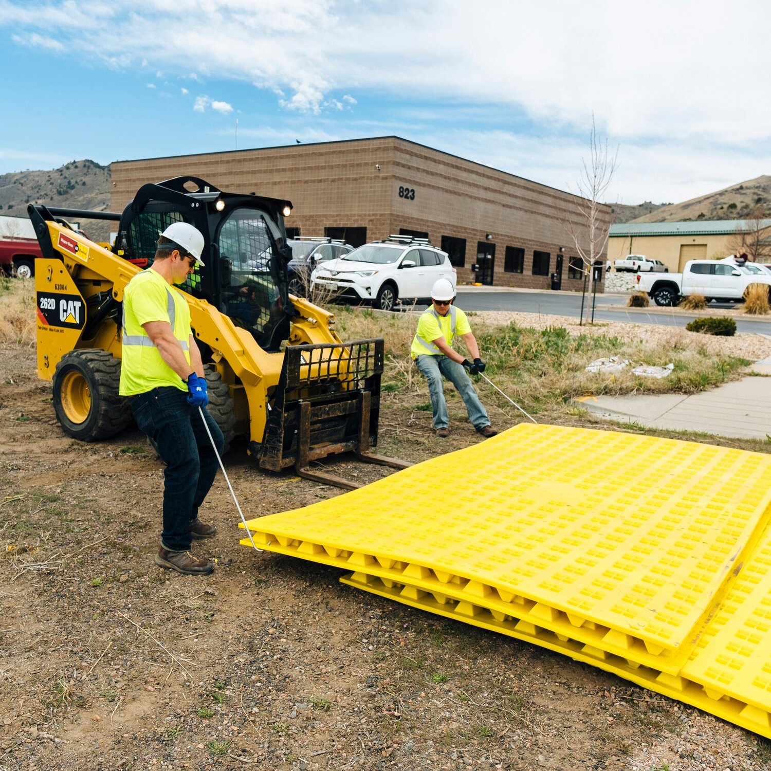 Person placing FODS tracking control mats in place