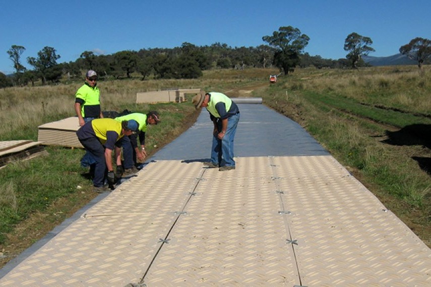 Workers assembling DuraDeck mats