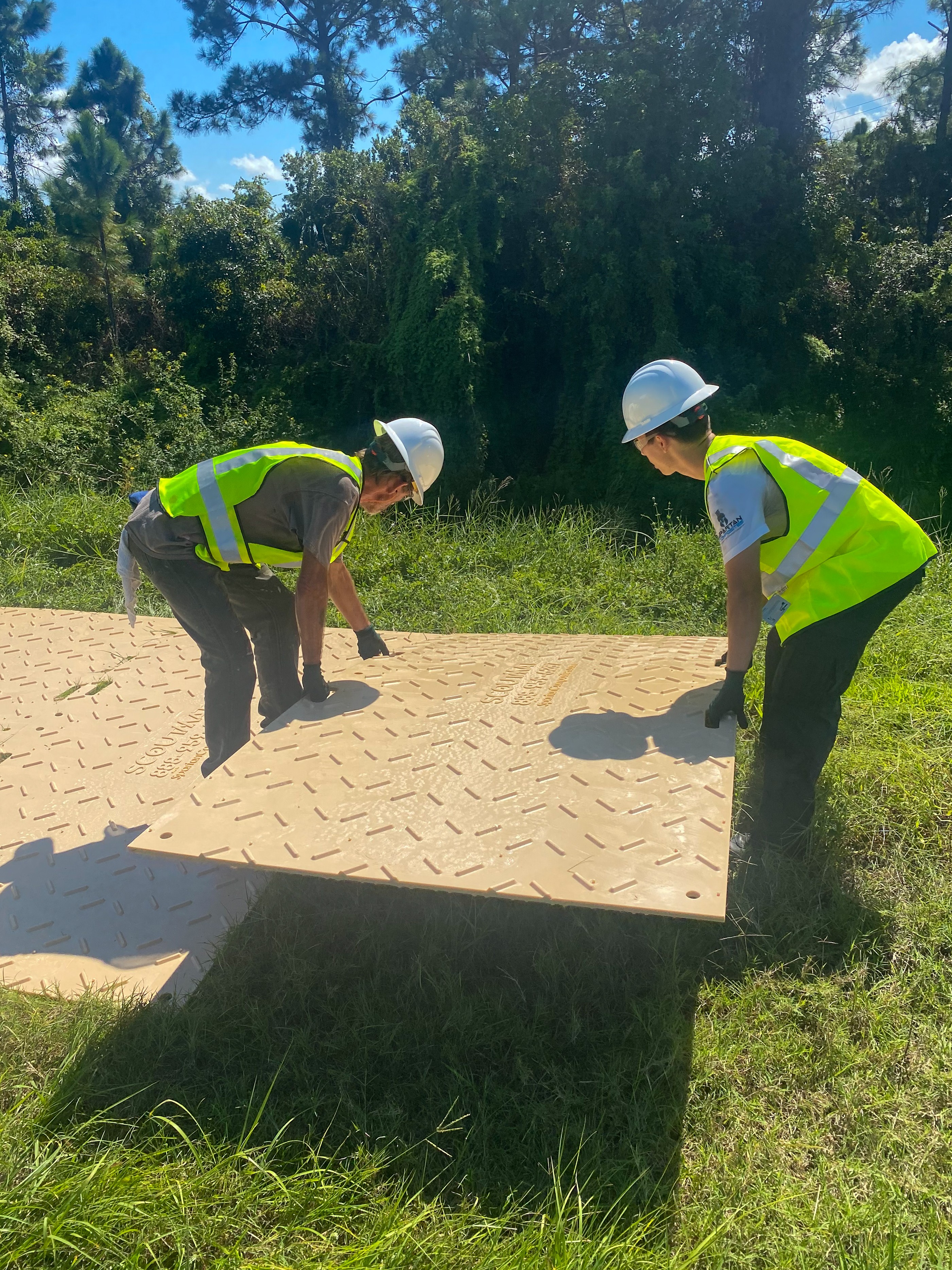 Two people lifting Scout Mats™